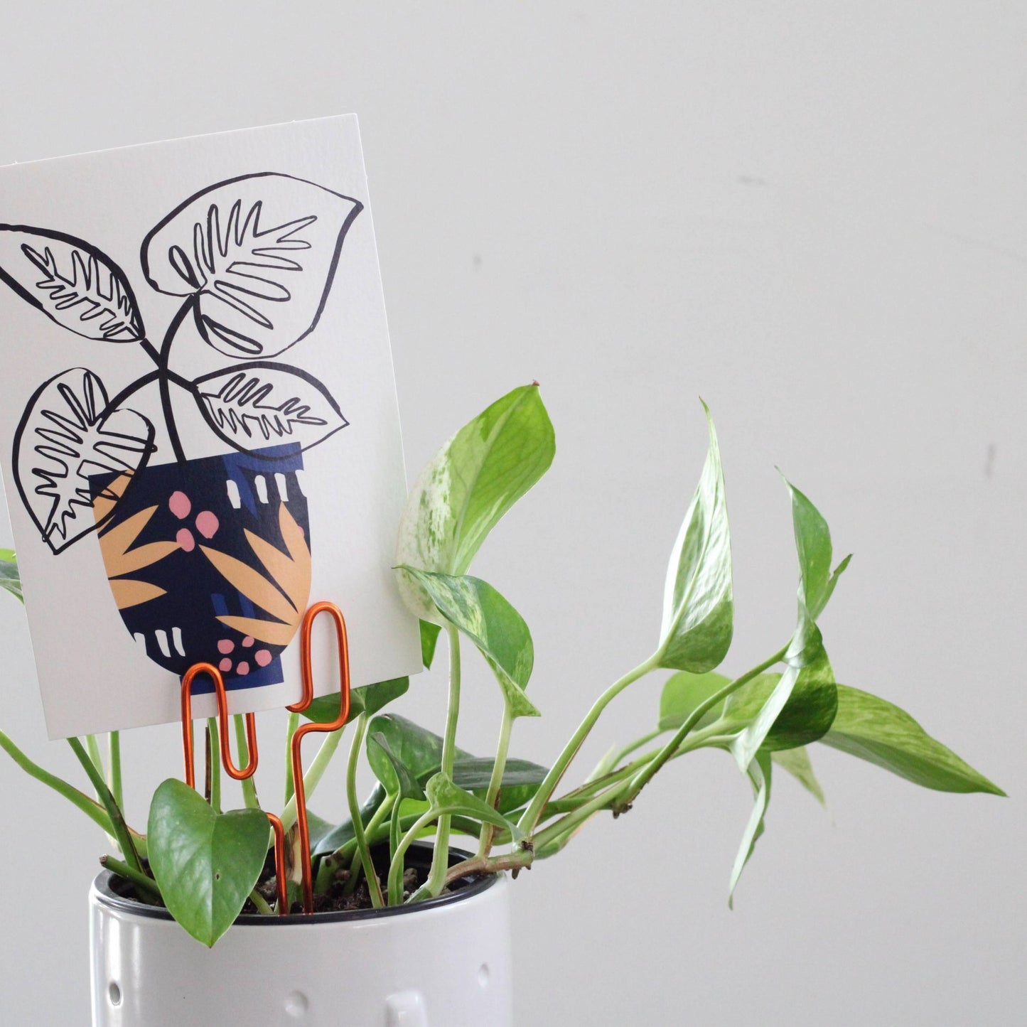 Decorative cactus-shaped plant stake handcrafted from dark copper aluminium with an example gift card; doubles as a plant support and a unique gift card holder—perfect as a sustainable plant gift idea.